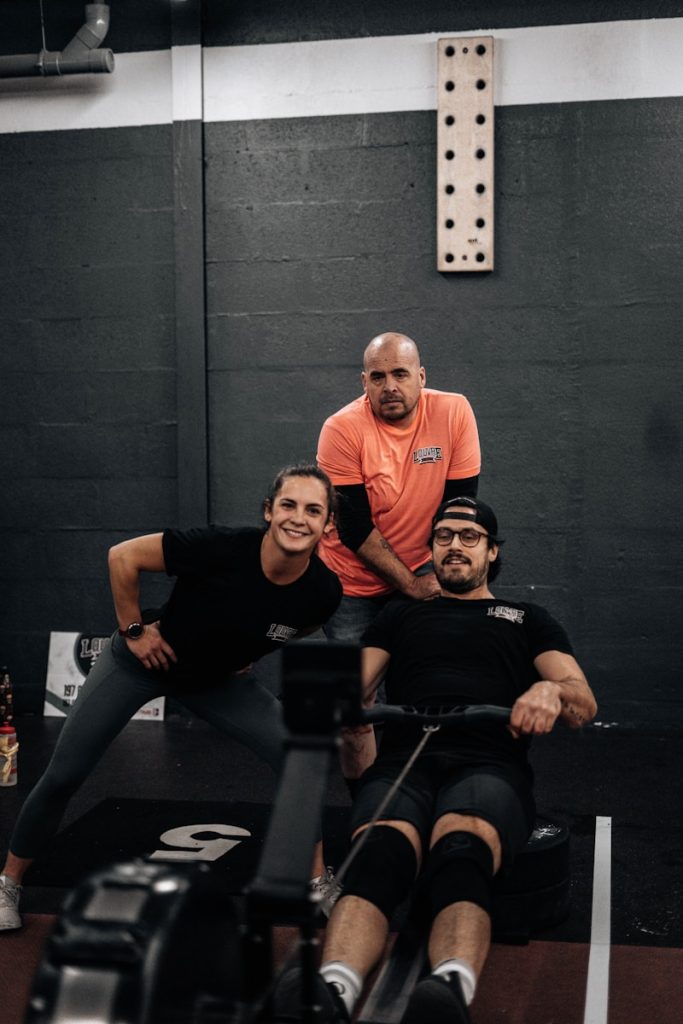 a group of people sitting on top of a gym floor