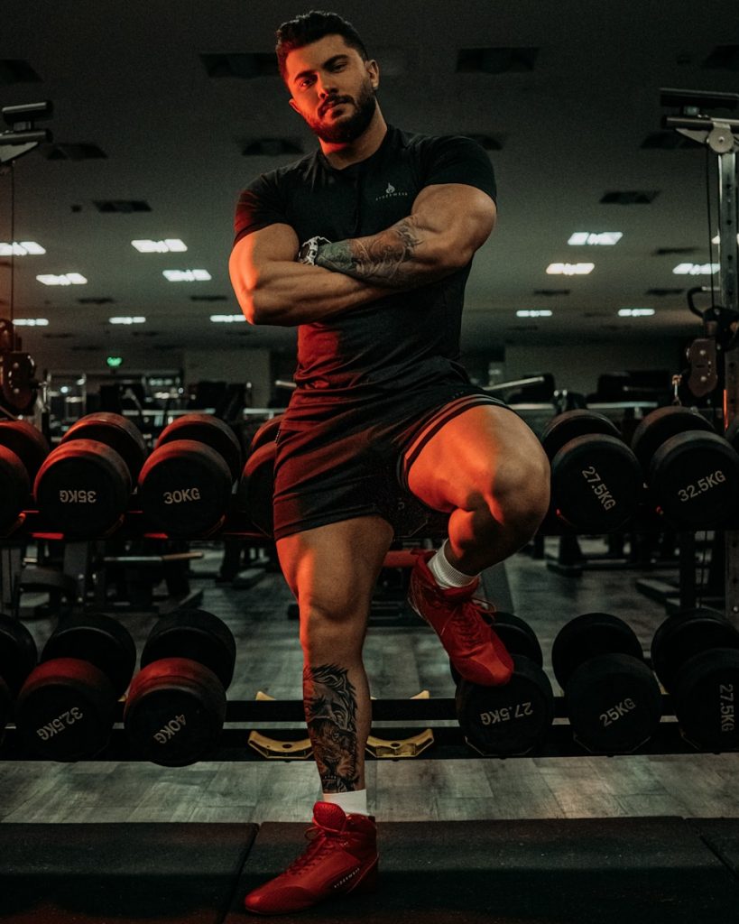 a man in a gym with his arms crossed