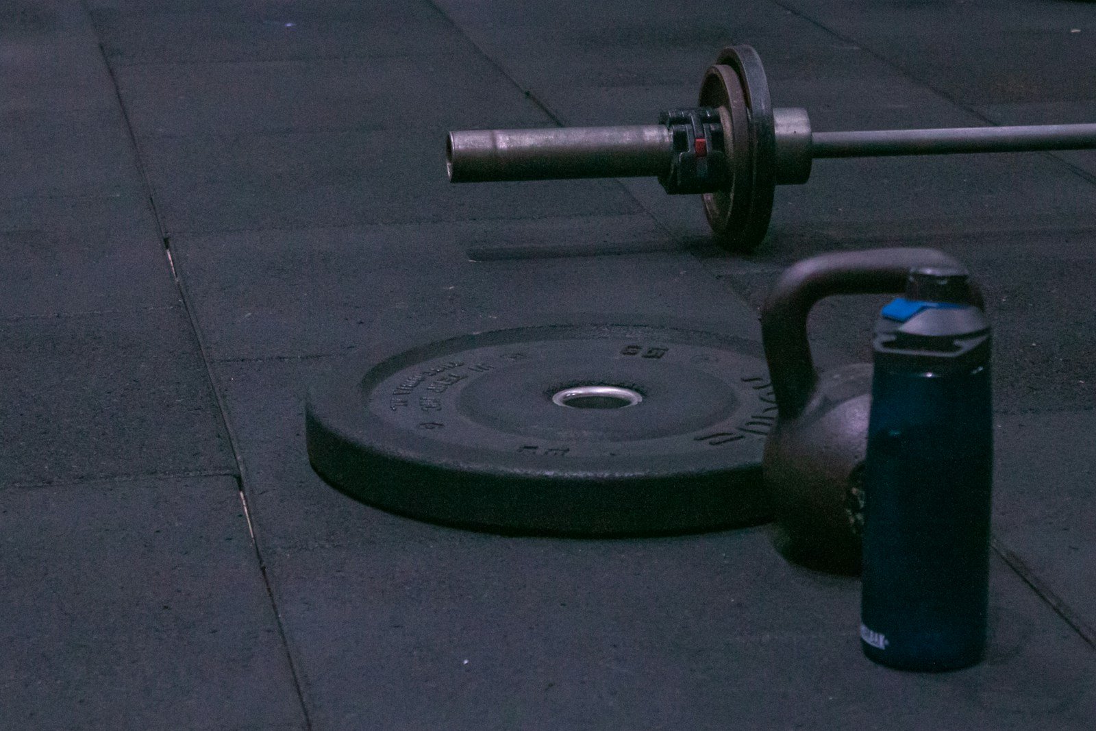A gym equipment laying on the ground on a sidewalk