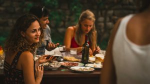 a group of people sitting around a table eating food